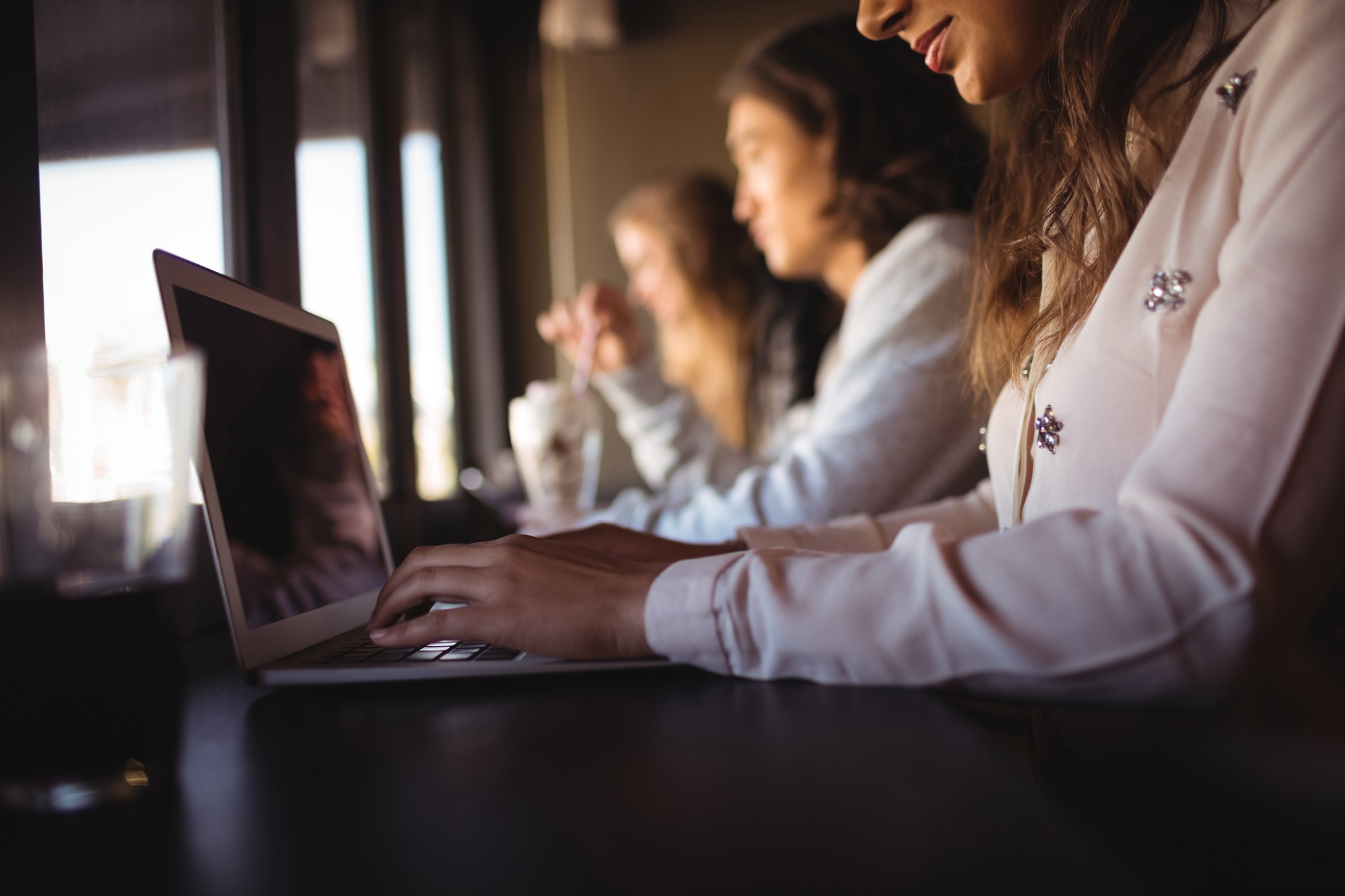 Woman using laptop in restaurant