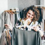 Plus Size Woman Choose Fashioned Dress in Store. Plus size women shopping.